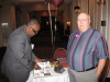 Leigh Burton checks a yearbook while John Tate welcomes him